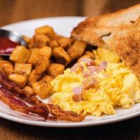 Ham Scrambler · Three eggs scrambled with ham and cheddar cheese, your choice of applewood smoked bacon or m...