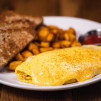 Maryland Omelette · Omelette with lump crab meat, swiss cheese, oven roasted tomatoes, topped with hollandaise a...