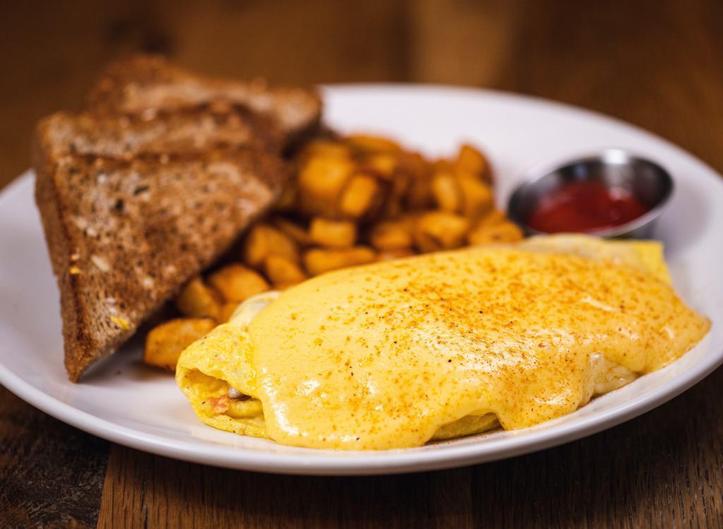 Maryland Omelette · Omelette with lump crab meat, swiss cheese, oven roasted tomatoes, topped with hollandaise and dusted with old bay seasoning, served with Toast and hashbrowns.