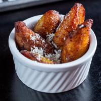 Maduros · Sweet plantains topped with queso fresco.