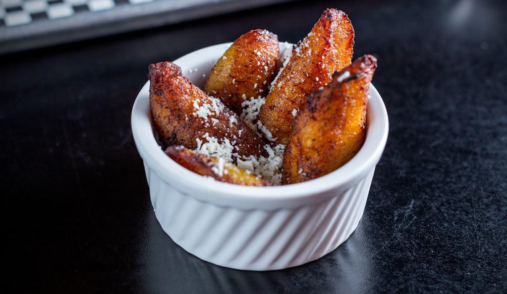 Maduros · Sweet plantains topped with queso fresco.