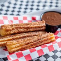 Churros · Dusted with cinnamon sugar and served with chocolate sauce.