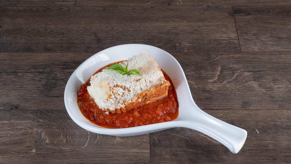 Meat Lasagna · Beef, tomato, mozzarella over layers of tender pasta, topped with marinara sauce and baked with cheese. Served with freshly baked breadsticks.