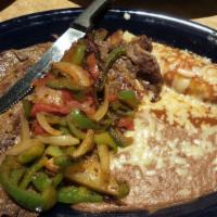 Steak Jalisco · 12 ounce rib-eye steak with bell peppers, onions and tomatoes. Served with beans, rice and t...