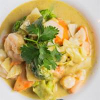 Thai Green Curry · Spicy, gluten free. Homemade green curry with coconut milk served with carrot, onions, cabba...