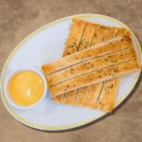 Bread Sticks Galore · Breadsticks freshly baked to a golden brown, covered with Parmesan cheese, olive oil, basil,...