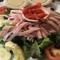 Italian Antipasto · House salad topped with pinwheels of ham, salami, provolone, artichokes, roasted red peppers...