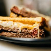 Ground Melt · Two 1/3 lb. beef patties topped with caramelized onions, Swiss and American cheese, homemade...