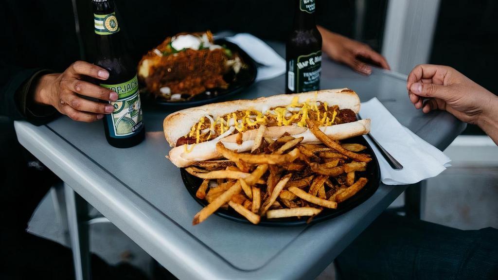 The Dogfather · 1/2lb footlong all beef hot dog served on authentic New Orleans  French Bread.. Choice of side, condiments on table or per request(takeout only). Comes with choice of Chili(spicy) & Cheese and one complimentary ranch or spicy ranch. Additional sauces are .50 per and found in sauces and sides category.