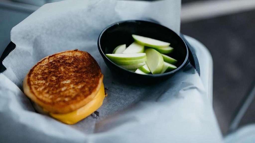 Kids Grilled Cheese · Choice of fries or apple slices and choice of soft drink, white or chocolate milk, or apple juice.