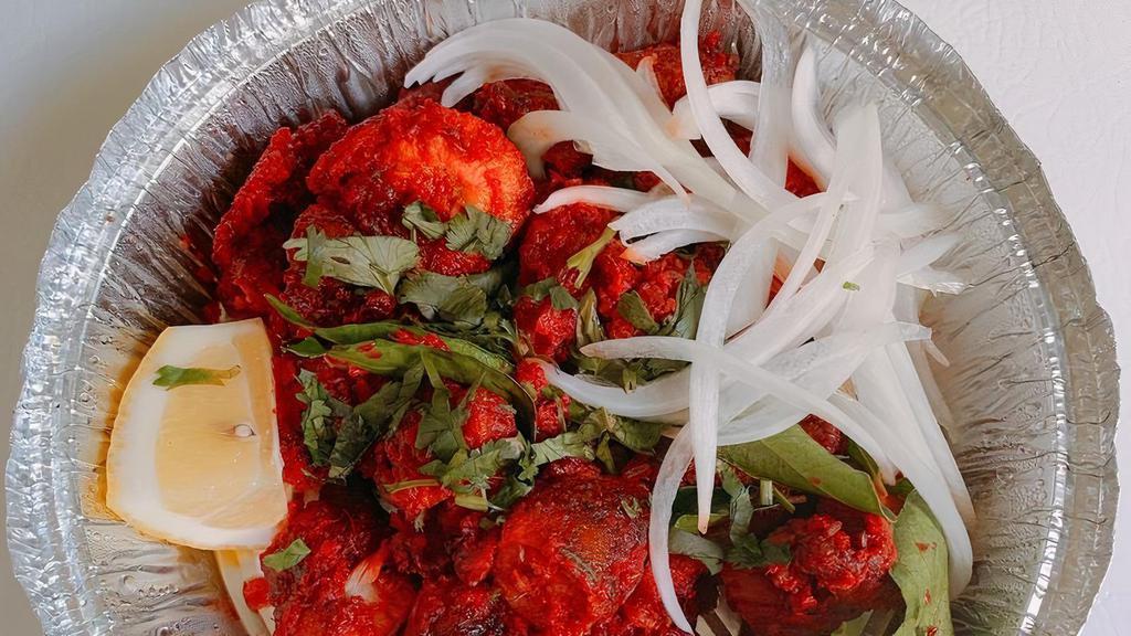 Chicken 65 · Fried chicken soaked in yogurt, flavored with herbs, spices, red chilies, mustard seeds and fresh curry leaves.