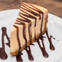 Cheesecake · New York style cheesecake on top of a graham cracker crust, served plain.