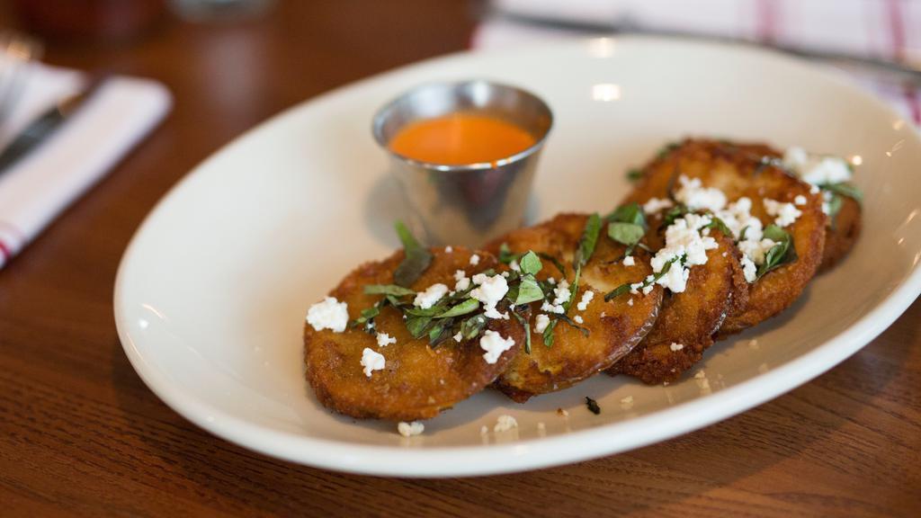 Fried Green Tomatoes · Vegetarian. Served with goat cheese, basil, and roasted red pepper vinaigrette.