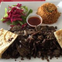 Doner Kebab · Shaved lamb marinated with fresh onions olive oil black pepper and oregano all slow cooked o...