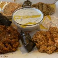 Appetizer Combo · Experience the tastes of the following appetizers all in one plate; hummus, babaganus, carro...