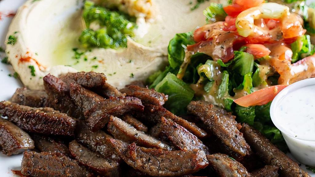 Gyro Plate · Spiced lamb and beef topped with tahini sauce.