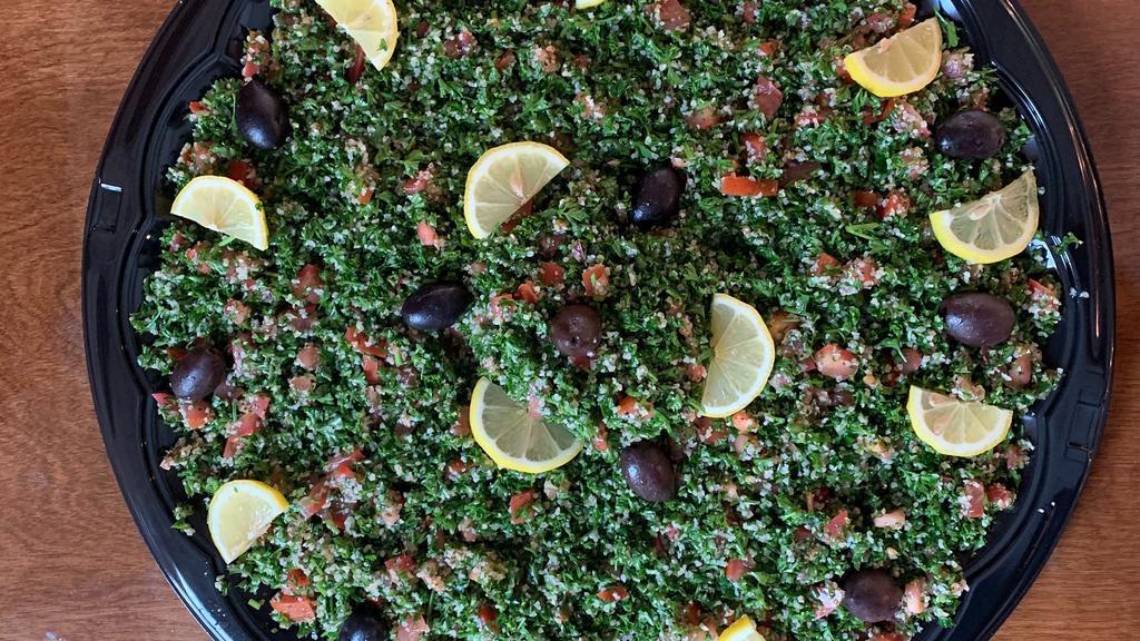 Tabouleh · Cracked wheat, parsley, tomatoes served with olive oil & lemon juice dressing.