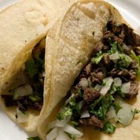 Carne Asada · Sliced steak grilled with onions. Served with rice, beans, and guacamole salad.
