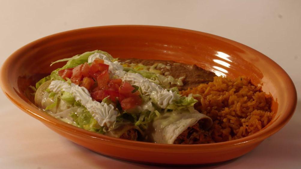 On The Border · One chicken enchilada, one chicken burrito topped with cheese dip, lettuce, tomato, and sour cream seared with rice and beans.