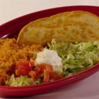 Quesadilla Mexicana · A flour cheese quesadilla stuffed with shredded beef or chicken and beans served with rice a...