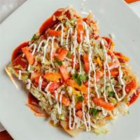 Enchiladas Deluxe · One beef, one chicken, one cheese and one bean enchiladas topped with ranchera sauce, lettuc...
