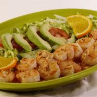 Camarones Al Mojo · Tender shrimp grilled with a garlic sauce and served on a bed of rice. Served with lettuce, ...