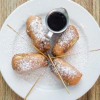 Sausage Skewers · Chicken sausage dipped in pancake batter, deep fried and dusted with powdered sugar.