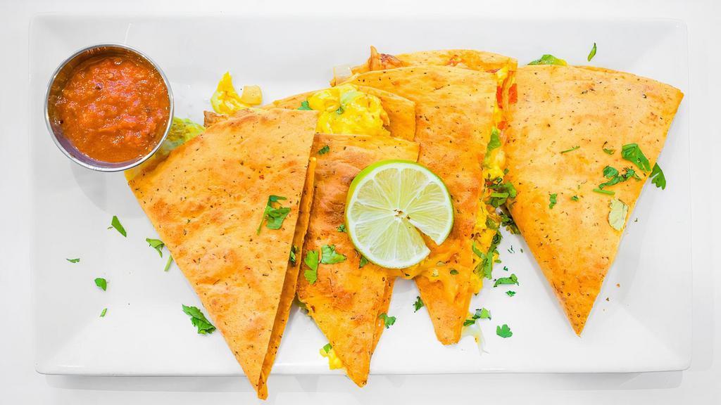 Breakfast Quesadilla · Eggs, onion, peppers, diced chicken, cheese inside a grilled tomato basil tortilla and served with sour cream and salsa.
