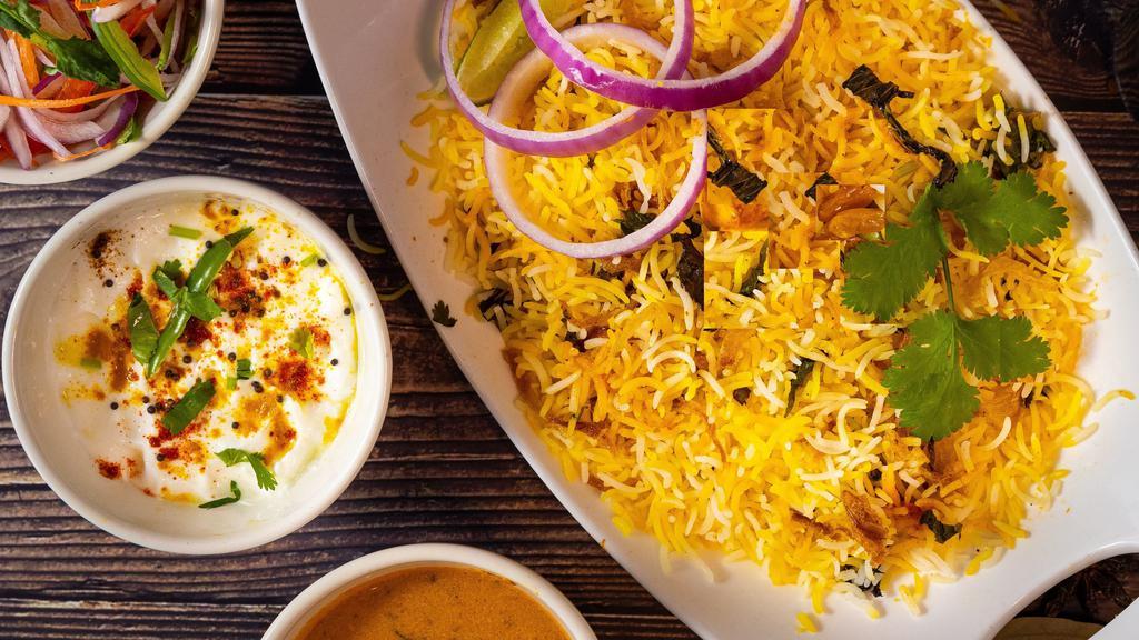 Veg Biryanis · Basmati rice cooked with choice of vegetables or paneer, blended with herbs and spices, and then garnished with onion and lemon. Served with Yogurt raita and Mirchi ka salan.