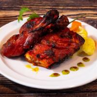  Chicken Tandoori  · Chicken marinated in yoghurt, blended with ginger, garlic, herbs, spices, and then grilled i...