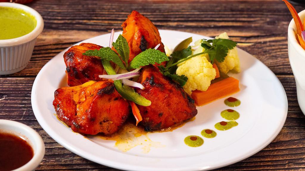 Chicken Tikka · Chicken cubes marinated overnight in a blend of spices and creamy yoghurt fire grilled in a tandoor clay oven.