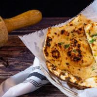 Garlic Naan · Bread baked in tandoor grill & topped with garlic.