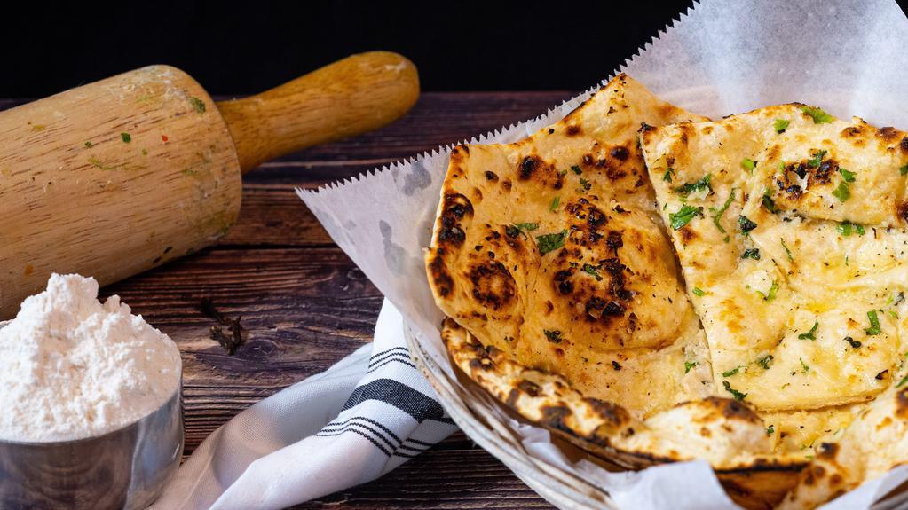 Garlic Naan · Bread baked in tandoor grill & topped with garlic.