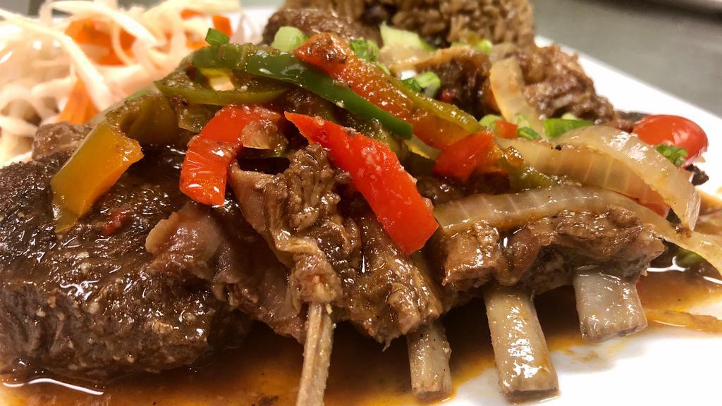 Chivo Guisado / Braised Goat · Braised goat served with a small salad and your choice of side.