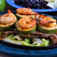 Fiesta Grande Steak · Marinated Top sirloin steak grilled to perfection with zucchini and shrimp. Served with Mexi...