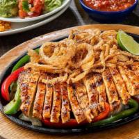 Honey-Chipotle Chicken Fajitas · Mesquite fire-grilled chicken fajitas topped with our favorite sweet-heat honey-chipotle sau...