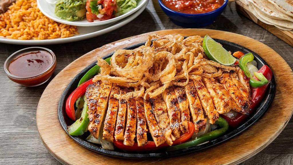 Honey-Chipotle Chicken Fajitas · Mesquite fire-grilled chicken fajitas topped with our favorite sweet-heat honey-chipotle sauce and fried onion strings. Served with hand-pressed flour tortillas, pico de gallo, cheese, Mexican rice and choice of beans.