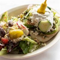 Grilled Veggie Gyro · Hummus, mixed garden vegetables, tabouli, & feta cheese, served with tzatziki sauce and a he...