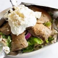 Lamb & Beef Gyro Pita · Slices of marinated rotisserie lamb and beef gyro meat served on a pita with lettuce, tomato...