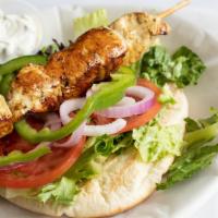 Chicken Souvlaki · Skewered chicken breast marinated with olive oil, garlic, lemon juice, and Greek spices. Ser...