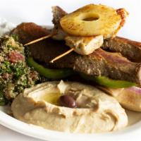 Mixed Grill Platter · Chicken souvlaki and gyro meat, with sides of hummus and tabouli-Served with tzatziki sauce,...