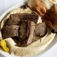 Hummus & Gyro Platter · A generous bed of hummus, topped with lamb and beef gyro meat, sprinkled with olive oil.