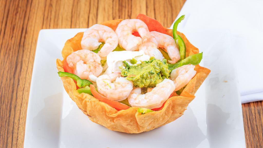 Shrimp Salad · A crispy flour tortilla bowl filled with lettuce, grilled shrimp, fresh onion, tomato and bell pepper, topped with cheese dip and bacon.