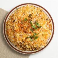 Chicken Dum Biryani · Tender marinated chicken served over basmati rice, topped with cilantro.