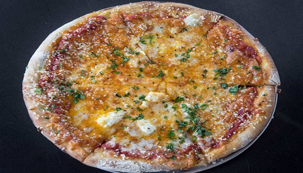 The Cheese Pizza · Pizza sauce, provolone, mozzarella, cheddar, feta, grated Parmesan and chopped herbs. Vegetarian.
