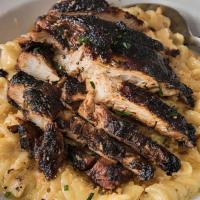 Midtown Mac-N-Cheese · Rotini pasta tossed in rich white cheddar sauce with cornbread topping and grilled or blacke...