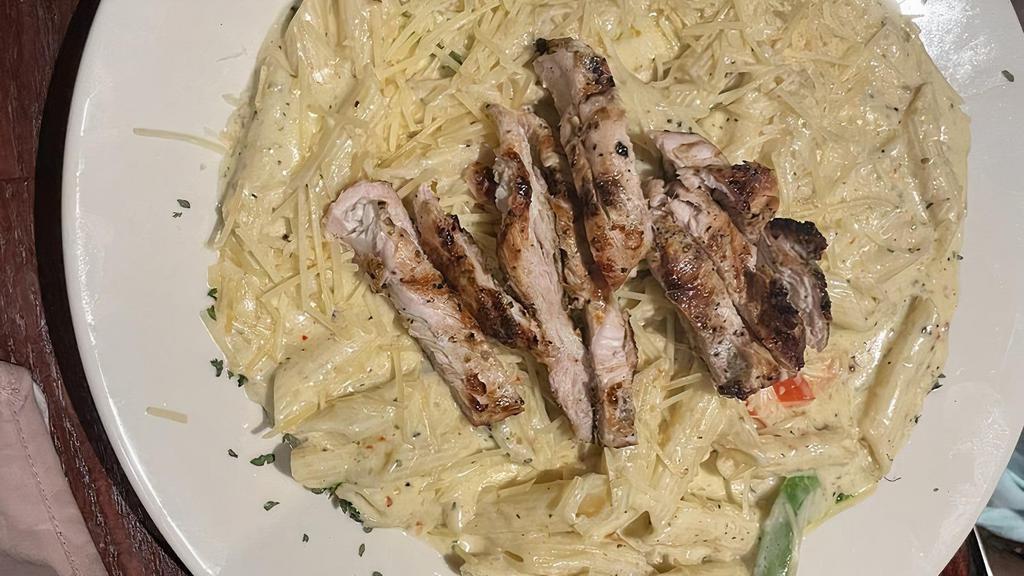 Grilled Chicken & Pasta Alfredo · Homemade Alfredo sauce with vegetables tossed in penne pasta. Topped with grilled chicken breast slices and  parmesan cheese. Served with garden salad and french bread.