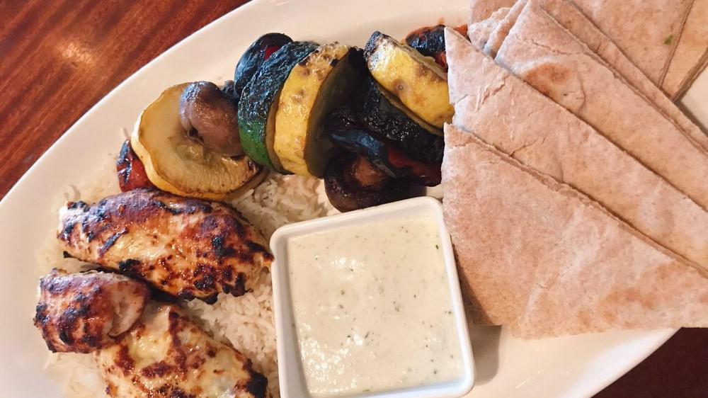Grilled Chicken Platter · Saffron marinated all natural grilled chicken served over basmati rice with marinated and grilled vegetables and flatbread.