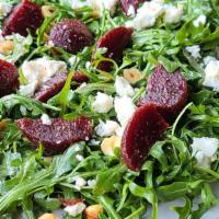 Arugula Salad · Arugula greens, feta cheese, organic roasted beets, hazelnuts with citrus vinaigrette.