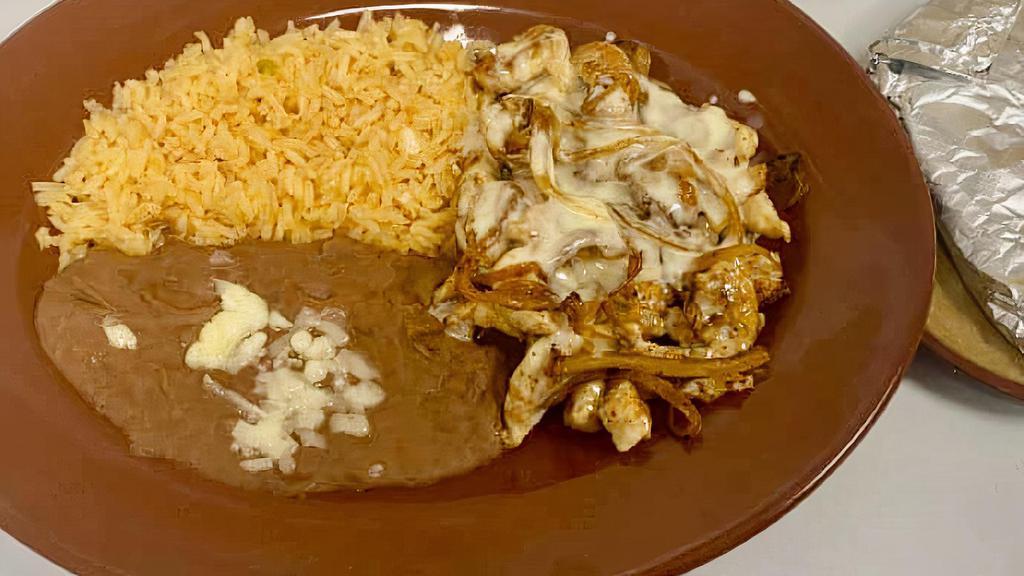 Pollo A La Crema · Strips of chicken breast soaked with onions and a delicious creamy Parmesan Mexican cheese sauce.